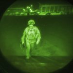 
              In this image made through a night vision scope and provided by the U.S. Army, Maj. Gen. Chris Donahue, commander of the U.S. Army 82nd Airborne Division, XVIII Airborne Corps, boards a C-17 cargo plane at Hamid Karzai International Airport in Kabul, Afghanistan, Monday, Aug. 30, 2021, as the final American service member to depart Afghanistan. (Master Sgt. Alexander Burnett/U.S. Army via AP)
            
