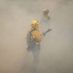 Firefighters are enveloped in smoke as they extinguish a backfire set to prevent the Caldor Fire from spreading near South Lake Tahoe, Calif., Thursday, Sept. 2, 2021. (AP Photo/Jae C. Hong)