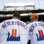 
              New York Mets fans wear jerseys to remember the 20th anniversary of the 9/11 terrorist attacks before a baseball game against the New York Yankees on Saturday, Sept. 11, 2021, in New York. (AP Photo/Adam Hunger)
            