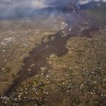 
              Lava from a volcano eruption flows on the island of La Palma in the Canaries, Spain, Thursday, Sept. 23, 2021. A volcano on a small Spanish island in the Atlantic Ocean erupted on Sunday, forcing the evacuation of thousands of people. Experts say the volcanic eruption and its aftermath on a Spanish island could last for up to 84 days. (AP Photo/Emilio Morenatti, Pool)
            