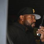 
              This image released by Netflix shows director Antoine Fuqua working from a vehicle on the set of "The Guilty." (Glen Wilson/Netflix via AP)
            