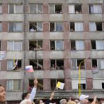 
              Residents wait for Pope Francis arrival to meet members of the Roma community at Lunik IX, in Kosice, Slovakia, Tuesday, Sept. 14, 2021, the biggest of about 600 shabby, segregated settlements where the poorest 20% of Slovakia's 400,000 Roma live. Pope Francis traveled to Kosice, in the far east of Slovakia on Tuesday to meet with the country's Roma in a gesture of inclusion for the most socially excluded minority group in Slovakia, who have long suffered discrimination, marginalization and poverty. (AP Photo/Gregorio Borgia)
            