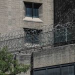 
              FILE - This Aug. 10, 2019, shows razor wire fencing at the Metropolitan Correctional Center in New York. Once hailed as a prototype for a new kind of federal jail and the most secure in the country, the Metropolitan Correctional Center has become a blighted wreck, with infrastructure so crumbling it’s impossible to safely house inmates there. And so the Justice Department said last month it would close the jail by the end of October to undertake much-needed repairs. But it may never reopen. (AP Photo/Bebeto Matthews, File)
            