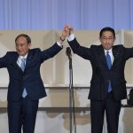 
              Japanese former Foreign Minister Fumio Kishida, right, celebrates with outgoing Prime Minister Yoshihide Suga after being announced the winner of the Liberal Democrat Party leadership election in Tokyo Wednesday, Sept. 29, 2021. Kishida won the governing party leadership election on Wednesday and is set to become the next prime minister, facing the imminent task of addressing a pandemic-hit economy and ensuring a strong alliance with Washington to counter growing regional security risks. (Carl Court/Pool Photo via AP)
            