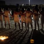 
              Women take part in a Tashlich ceremony, where they wrote down things they want to release before casting them into a fire, on the beach in Tel Aviv, Israel, Tuesday, Sept. 14, 2021. Tashlich, which means 'to cast away' in Hebrew, is the practice by which Jews go to a large flowing body of water and symbolically 'throw away' their sins by throwing a piece of bread, or similar food, into the water before the Jewish holiday of Yom Kippur, the holiest day in the Jewish year which starts at sundown Wednesday. (AP Photo/Maya Alleruzzo)
            