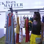 
              Fashion designer Fallylah Nyny Ryke Goungou, from Togo, poses in front her creations, part of the Black Lives Matter Spring Summer 2022 collective fashion event, unveiled during the Milan Fashion Week, in Milan, Italy, Tuesday, Sept. 21, 2021. (AP Photo/Antonio Calanni)
            