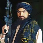 
              In this undated image Hemad Sherzad holding his M-4 rifle,  poses for a photo outside of Hamid Karzai International Airport in Kabul, Afghanistan. After several sleepless nights from the unrelenting thunder of U.S. evacuation flights overhead, Hemad Sherzad joined his fellow Taliban fighters in celebration from his post at the airport. “We cried for almost an hour out of happiness,” Sherzad told The AP. “We yelled a lot — even our throat was in pain.” (Courtesy of Hamed Sherzad via AP)
            