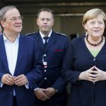 
              German Chancellor Angela Merkel and North Rhine-Westphalia's State Premier, chairman of the Christian Democratic Union party and candidate for Chancellery Armin Laschet, left, visit the fire station in Schalksmuehle, Germany, Sunday Sept. 5, 2021. (Thilo Schmuelgen/Pool via AP)
            