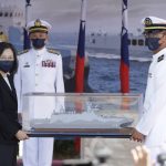
              Taiwan's President Tsai Ing-wen, left, holds a model ship during the commissioning ceremony of the the domestically made Ta Jiang warship at the Suao naval base in Yilan county, Taiwan, Thursday, Sept. 9, 2021. Taiwan's president oversaw the commissioning of a new domestically made navy warship Thursday as part of the island's plan to boost indigenous defense capacity amid heightened tensions with China. (AP Photo/Chiang Ying-ying)
            