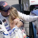 
              Dale Earnhardt Jr., comforts his daughter Isla, 3, during driver introductions prior to the start of the NASCAR Xfinity auto race in Richmond, Va., Saturday, Sept. 11, 2021. (AP Photo/Steve Helber)
            