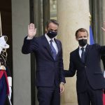 
              French President Emmanuel Macron and Prime Minister Kyriakos Mitsotakis, center, wave Tuesday, Sept. 28, 2021 at the Elysee Palace in Paris. The leaders of Greece and France are expected to announce a major, multibillion-euro deal in Paris on Tuesday involving the acquisition by Greece of at least six French-built warships, Greek state ERT TV reported. (AP Photo/Francois Mori)
            