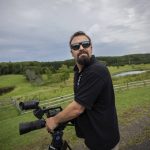 
              Korey Rowe uses his video camera near his home in Oneonta, N.Y. on Thursday, Aug. 12, 2021. Korey Rowe served tours in Iraq and Afghanistan and returned to the U.S. in 2004 traumatized and disillusioned. His experiences overseas and nagging questions about Sept. 11, 2001 convinced him America's leaders were lying about what happened that day and the wars that followed. (AP Photo/Robert Bumsted)
            