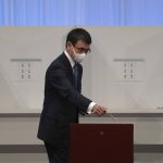 
              Taro Kono, Japan's vaccinations minister, casts his ballot in a runoff vote in the Liberal Democrat Party leadership election in Tokyo Wednesday, Sept. 29, 2021. Japan's governing party is voting to pick its new leader, with the presumed next prime minister facing imminent, crucial tasks such as addressing a pandemic-hit economy and ensuring a strong alliance with Washington amid growing regional security risks. (Carl Court/Pool Photo via AP)
            