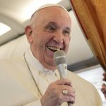 
              Pope Francis greets journalists aboard an airplane on his way to Hungary, Sunday, Sept. 12, 2021. Francis is opening his first foreign trip since undergoing major intestinal surgery in July, embarking on an intense, four-day, two-nation trip to Hungary and Slovakia that he has admitted might be overdoing it. (AP Photo/Gregorio Borgia, Pool)
            