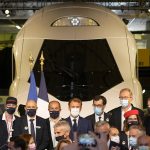 
              French President Emmanuel Macron, center, and other executives pose in front of a life-size replica of the next high-speed train TGV, at the Gare de Lyon station Friday, Sept. 17, 2021 in Paris. France unveils a super-fast, climate-friendly train of the future, the next generation of its high-speed TGV trains that have been emulated around the world. (AP Photo/Michel Euler, Pool)
            
