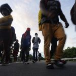 Haitian migrants walk along the highway in Huixtla, Chiapas state, Mexico, early Thursday, Sept. 2, 2021, in their journey north toward the U.S. (AP Photo/Marco Ugarte)