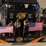 
              The pit crew of Noah Gragson (9) displays the U.S. flag during laps nine, ten and eleven during the NASCAR Xfinity auto race in Richmond, Va., Saturday, Sept. 11, 2021. (AP Photo/Steve Helber)
            