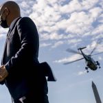 A Secret Service agent stands guard as Marine One with President Joe Biden abroad takes off from the South Lawn of the White House in Washington, Tuesday, Sept. 7, 2021, for a short trip to Andrews Air Force Base, Md., and then on to New York and New Jersey to survey damage from Hurricane Ida. (AP Photo/Andrew Harnik)