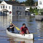 
              Residents canoe through floodwater in the aftermath of Hurricane Ida in Manville, NJ, Thursday, Sept. 2, 2021. A stunned U.S. East Coast has woken up to a rising death toll, surging rivers and destruction after the remnants of Hurricane Ida walloped the region with record-breaking rain. (AP Photo/Carlos Gonzalez)
            