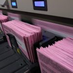 
              Mail in ballots run through a sorting machine at the Sacramento County Registrar of Voters office in Sacramento, Calif., Monday, Aug. 30, 2021. California voters have until Sept. 14 to cast their ballots to either keep Gov. Gavin Newsom in office are replace him with one of over 40 candidates on the recall ballot. In a state dominated by Democrats the outcome will depend on who takes the time to vote. (AP Photo/Rich Pedroncelli)
            