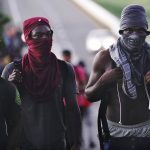 Haitian migrants walk along the highway in Huixtla, Chiapas state, Mexico, early Thursday, Sept. 2, 2021, in their journey north toward the U.S. (AP Photo/Marco Ugarte)