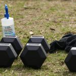 
              A bottle of disinfectant sits by gym equipment in a park in the eastern suburbs of Sydney Tuesday, Sept. 14, 2021. Personal trainers have turned a waterfront park at Sydney’s Rushcutters Bay into an outdoor gym to get around pandemic lockdown restrictions. (AP Photo/Mark Baker)
            