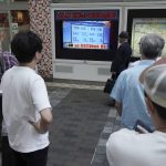 
              Pedestrians look at a public TV showing the results of the Liberal Democratic Party's presidential election Wednesday, Sept. 29, 2021, in Tokyo. Former Foreign Minister Fumio Kishida has won the governing party leadership election and is set to become the next prime minister. The Japanese letters read: "Fumio Kishida new LDP president." (AP Photo/Eugene Hoshiko)
            