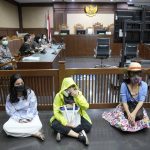 
              Activist wearing masks to represent those affected by air pollution, sit on the floor in protest before judges announce their verdict on a civil lawsuit filed against several Indonesian officials, including President Joko Widodo and Jakarta Governor Anies Baswedan for their failure to improve poor air quality in the capital city, inside a courtroom at Central Jakarta District Court in Jakarta, Indonesia, Thursday, Sept. 16, 2021. The court ruled Thursday that President Widodo and six other top officials have neglected to fulfill citizens' rights to clean air and ordered them to improve the poor air quality in the capital. (AP Photo/Dita Alangkara)
            