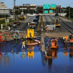 Workers pump water from a flooded section of Interstate 676 in Philadelphia Friday, Sept. 3, 2021 in the aftermath of downpours and high winds from the remnants of Hurricane Ida that hit the area.  The cleanup and mourning has continued as the Northeast U.S. recovers from record-breaking rainfall from the remnants of Hurricane Ida. (AP Photo/Matt Rourke)