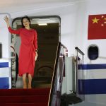 In this photo released by China's Xinhua News Agency, Huawei CFO Meng Wanzhou waves as she steps out of an airplane after arriving at Shenzhen Bao'an International Airport in Shenzhen in southern China's Guangdong Province, Saturday, Sept. 25, 2021. A top executive from global communications giant Huawei Technologies returned to China on Saturday following what amounted to a high-stakes prisoner swap with Canada and the U.S. (Jin Liwang/Xinhua via AP)