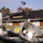 
              Crews work on a roof that was damaged in the aftermath of Hurricane Ida, Friday, Sept. 3, 2021, in LaPlace, La. (AP Photo/Matt Slocum)
            