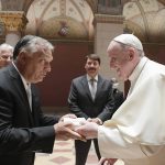 
              Pope Francis exchanges gifts with Hungarian Prime Minister Viktor Orban, at Budapest's Museum of Fine Arts, Sunday, Sept. 12, 2021. Francis is opening his first foreign trip since undergoing major intestinal surgery in July, embarking on an intense, four-day, two-nation trip to Hungary and Slovakia that he has admitted might be overdoing it. (Vatican Media via AP)
            