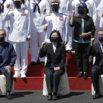 
              Taiwan's President Tsai Ing-wen, center, cheers with officers during the commissioning ceremony of the the domestically made Ta Jiang warship at the Suao naval base in Yilan county, Taiwan, Thursday, Sept. 9, 2021. Taiwan's president oversaw the commissioning of the new domestically made navy warship Thursday as part of the island's plan to boost indigenous defense capacity amid heightened tensions with China. (AP Photo/Chiang Ying-ying)
            