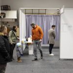 
              People vote at a local sports complex in Kopavogur, Iceland, Saturday, Sept. 25, 2021. Icelanders are voting in a general election dominated by climate change, with an unprecedented number of political parties likely to win parliamentary seats. (AP Photo/Arni Torfason)
            