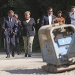 
              German Chancellor Angela Merkel, centre, walks with Armin Laschet, left, candidate for chancellor of the CDU/CSU and chairman of the CDU, and Fritz J'ckel, second from left, North Rhine-Westphalia's commissioner for reconstruction in flooded areas, as they vistit areas affected by flooding, in Hagen, Germany, Sunday, Sept. 5, 2021. (Oliver Berg/Pool Photo via AP)
            