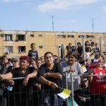 
              Residents wait for Pope Francis arrival to meet members of the Roma community at Lunik IX, in Kosice, Slovakia, Tuesday, Sept. 14, 2021, the biggest of about 600 shabby, segregated settlements where the poorest 20% of Slovakia's 400,000 Roma live. Pope Francis traveled to Kosice, in the far east of Slovakia on Tuesday to meet with the country's Roma in a gesture of inclusion for the most socially excluded minority group in Slovakia, who have long suffered discrimination, marginalization and poverty. (AP Photo/Gregorio Borgia)
            