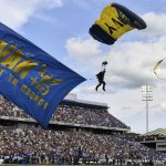 
              Leap Frogs airmen parachute into the stadium before an NCAA college football game, between Navy and Air Force, Saturday, Sept. 11, 2021, in Annapolis, Md. (AP Photo/Terrance Williams)
            