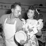 
              FILE - In this April 22, 1944 file photo,  Jane Powell, who just completed work in "Song of the Open Road" does her bit at the canteen drying dishes for dishwasher Buster Keaton, in Los Angeles. Jane Powell, the bright-eyed, operatic-voiced star of Hollywood's golden age musicals who sang with Howard Keel in “Seven Brides for Seven Brothers” and danced with Fred Astaire in “Royal Wedding,” has died. Thursday, Sept. 16, 2021. She was 92.  (AP Photo/File)
            