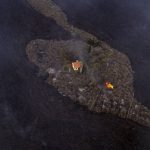 
              In this photo provided by iLoveTheWorld, a house remains intact as lava flows after a volcano erupted near Las Manchas on the island of La Palma in the Canaries, Spain, Monday, Sept. 20, 2021. A dormant volcano on a small Spanish island in the Atlantic Ocean erupted on Sunday, forcing the evacuation of thousands of people. Huge plumes of black-and-white smoke shot out from a volcanic ridge where scientists had been monitoring the accumulation of molten lava below the surface. (Alfonso Escalero/iLoveTheWorld via AP)
            