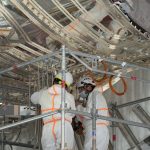 
              Workers inspect components of the ITER machine at the Tokamak complex in Saint-Paul-Lez-Durance, France, Thursday, Sept. 9, 2021. Scientists at the International Thermonuclear Experimental Reactor in southern France took delivery of the first part of a massive magnet so strong its American manufacturer claims it can lift an aircraft carrier. (AP Photo/Daniel Cole)
            