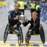 
              Marcel Hug, left, and Manuela Schar, both of Switzerland, celebrate after winning the wheelchair divisions of the 125th Boston Marathon on Monday, Oct. 11, 2021, in Boston. (AP Photo/Winslow Townson)
            