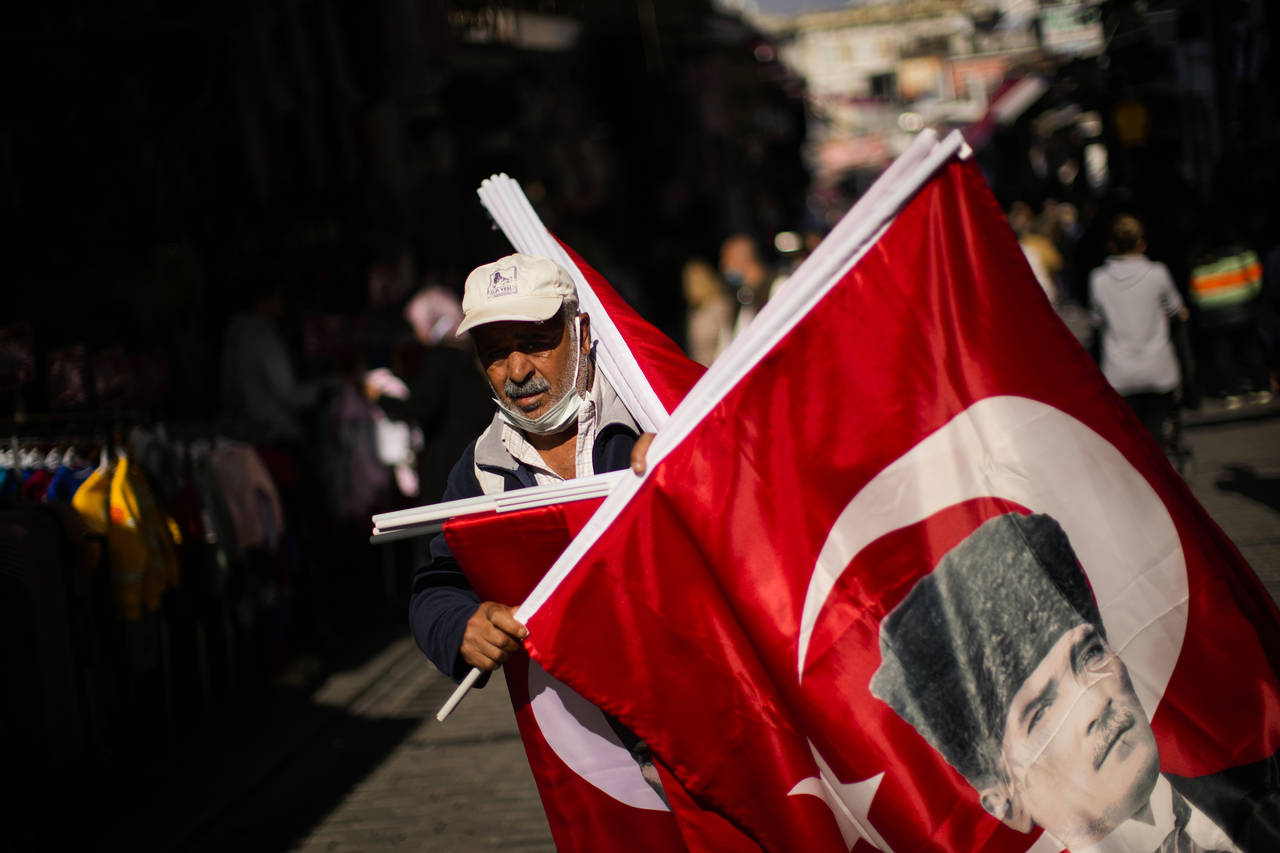 A vendor sells Turkish flags with the portrait of Mustafa Kemal Ataturk, founder of the modern Turk...
