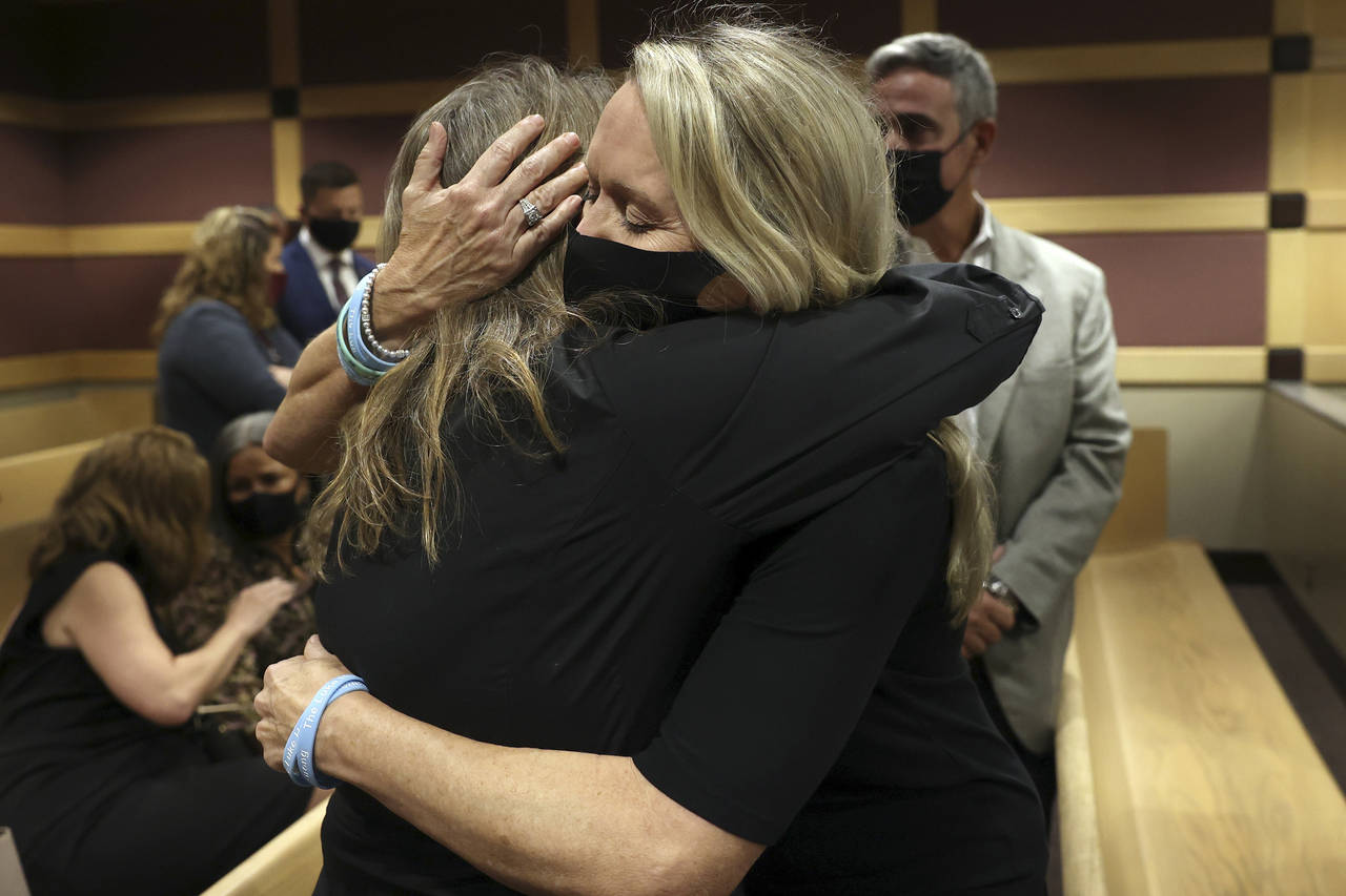 CORRECTS SPELLING OF FIRST NAME TO DEBBI, NOT DEBBIE- Gena Hoyer, right, hugs Debbi Hixon during a ...