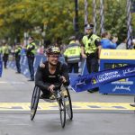 
              Manuela Schar, of Switzerland, breaks the tape to win the women's wheelchair division of the 125th Boston Marathon Monday, Oct. 11, 2021, in Boston. (AP Photo/Winslow Townson)
            