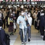
              Commuters wearing face masks walk in a passageway during a rush hour at Shinagawa Station Friday, Oct. 1, 2021, in Tokyo. Japan lifted its COVID-19 state of emergency in all of the regions today Oct.1. (AP Photo/Eugene Hoshiko)
            