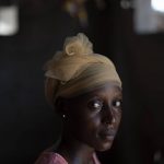 
              Lama Mballow poses for a picture in her house at the Sare Gibel village, in Bansang, Gambia, Wednesday, Sept. 29, 2021. Sare Gibel, where the 24-year-old mother lives, is 5.5 kms (3 miles) away from the local hospital. Mballow, mother of one and pregnant with another child, has no plans to get vaccinated after giving birth. She says that in her village a lot of people are afraid of the vaccine. "I don't want to give a problem to my baby. Yes, that's why I'm afraid", says Mballow. (AP Photo/Leo Correa)
            