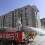 
              In this photo released by Xinhua News Agency, a worker disinfects a residential area in Dalai Hubu Township in Ejina Banner of Alxa League, in northern China's Inner Mongolia Autonomous Region, Wednesday, Oct. 27, 2021. More than 2,000 tourists visiting China's Inner Mongolia region have been sent to hotels to undergo two weeks of quarantine following the detection of new cases of COVID-19 in the area. (Bei He/Xinhua via AP)
            