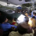 
              Soldiers and volunteers load the national flag-wrapped casket of Pakistan's nuclear scientist Abdul Qadeer Khan into a vehicle, following a funeral prayer, in Islamabad, Pakistan on Sunday, Oct. 10, 2021. Khan, a controversial figure known as the father of Pakistan's nuclear bomb, died Sunday of COVID-19 following a lengthy illness, his family said. He was 85. (AP Photo/Anjum Naveed)
            