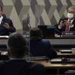 
              Senators Omar Aziz, left, and Renan Calheiros, attend a session by their commission investigating the government's management of the COVID-19 pandemic at the Federal Senate in Brasilia, Brazil, Tuesday, Oct. 26, 2021. (AP Photo/Eraldo Peres)
            