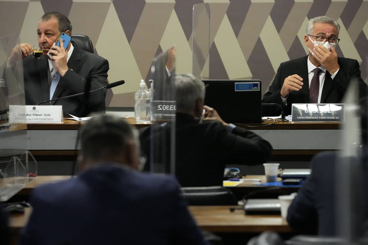 Senators Omar Aziz, left, and Renan Calheiros, attend a session by their commission investigating t...